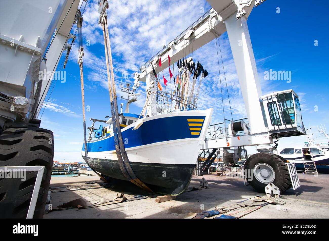 Wide Angle Photo Of Fishing Boat Lifted By A Boat Lift Blue And White Boat White Boat Lift And Blue Sky Stock Photo Alamy