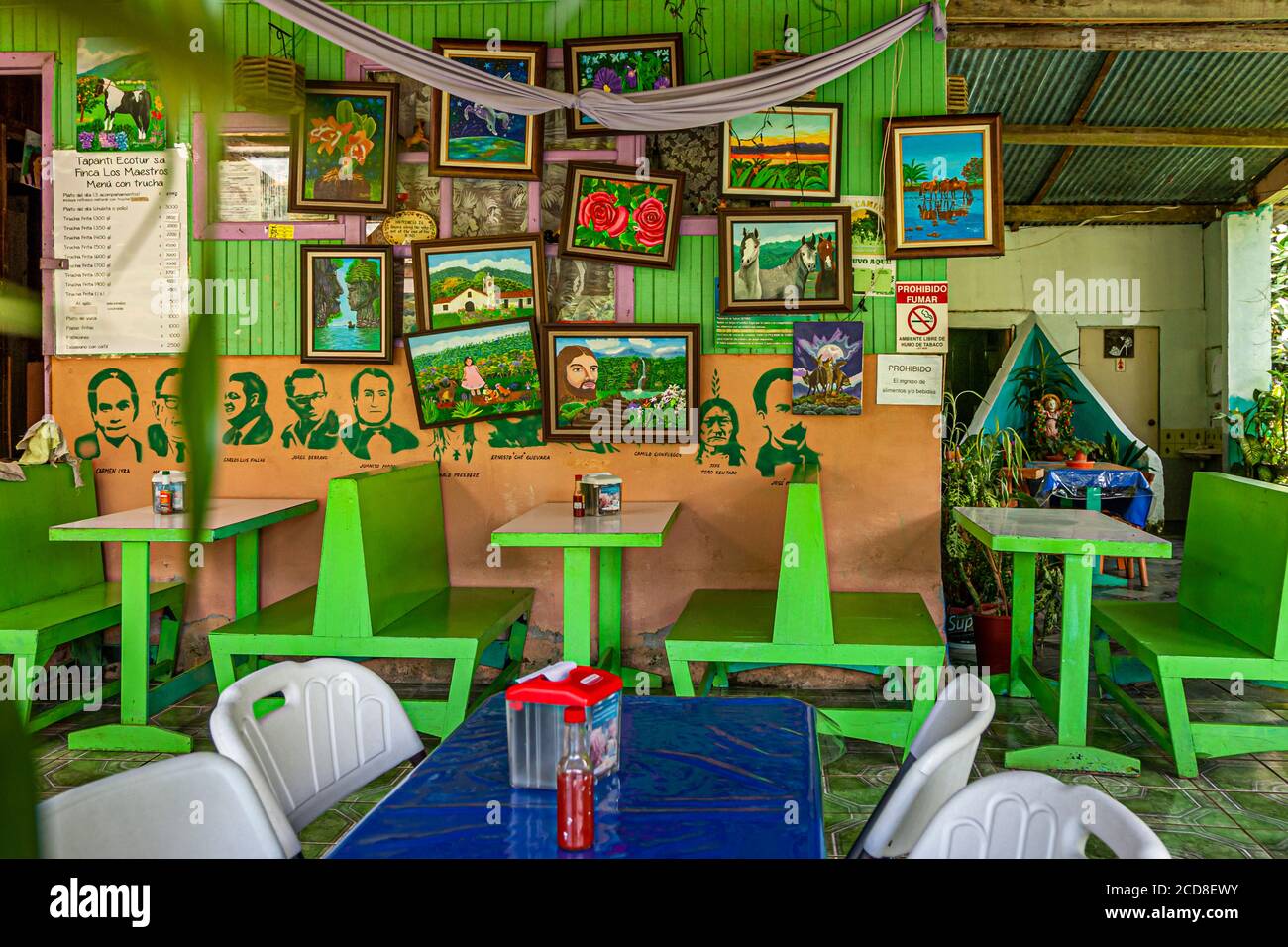 Restaurant in Costa Rica with naive paintings and stenciled portraits of South American politicians Stock Photo