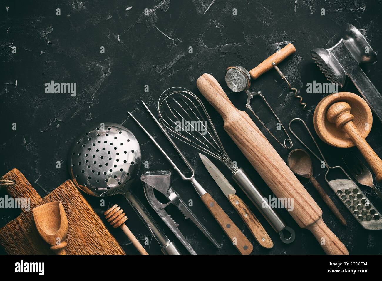 Various kitchen utensils and tools on a black stone background, corner frame. Top view, flat lay, copy space. Collection kitchenware Stock Photo