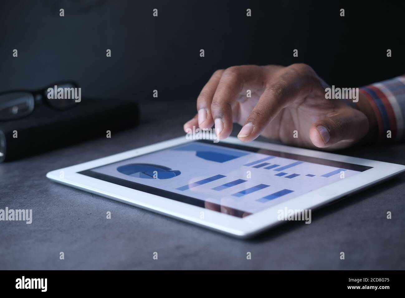 man's hand working on digital tablet at office desk, using self created ...