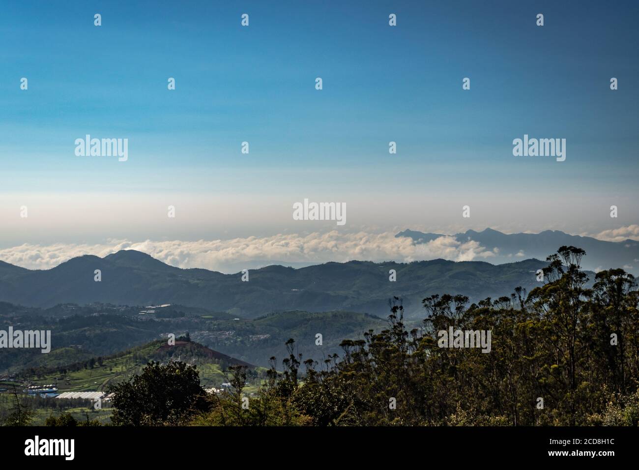 mountain range with cloud layers and green forest image is taken at south india. it is showing the beautiful landscape of south india. Stock Photo