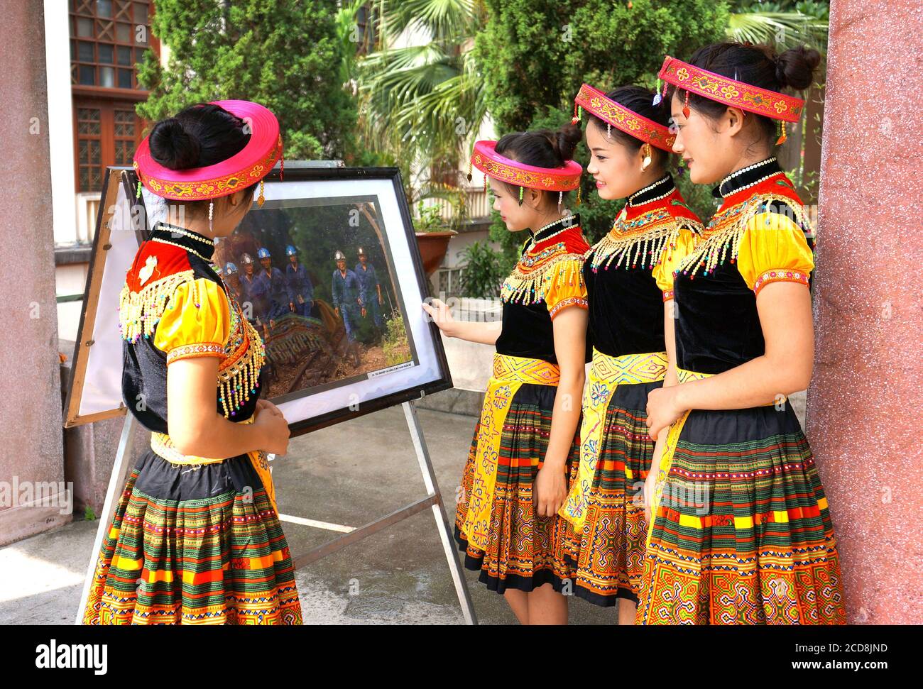A group of Hmong ethnic women watching an outdoor photo exhibition, Thai Nguyen, Vietnam. Stock Photo
