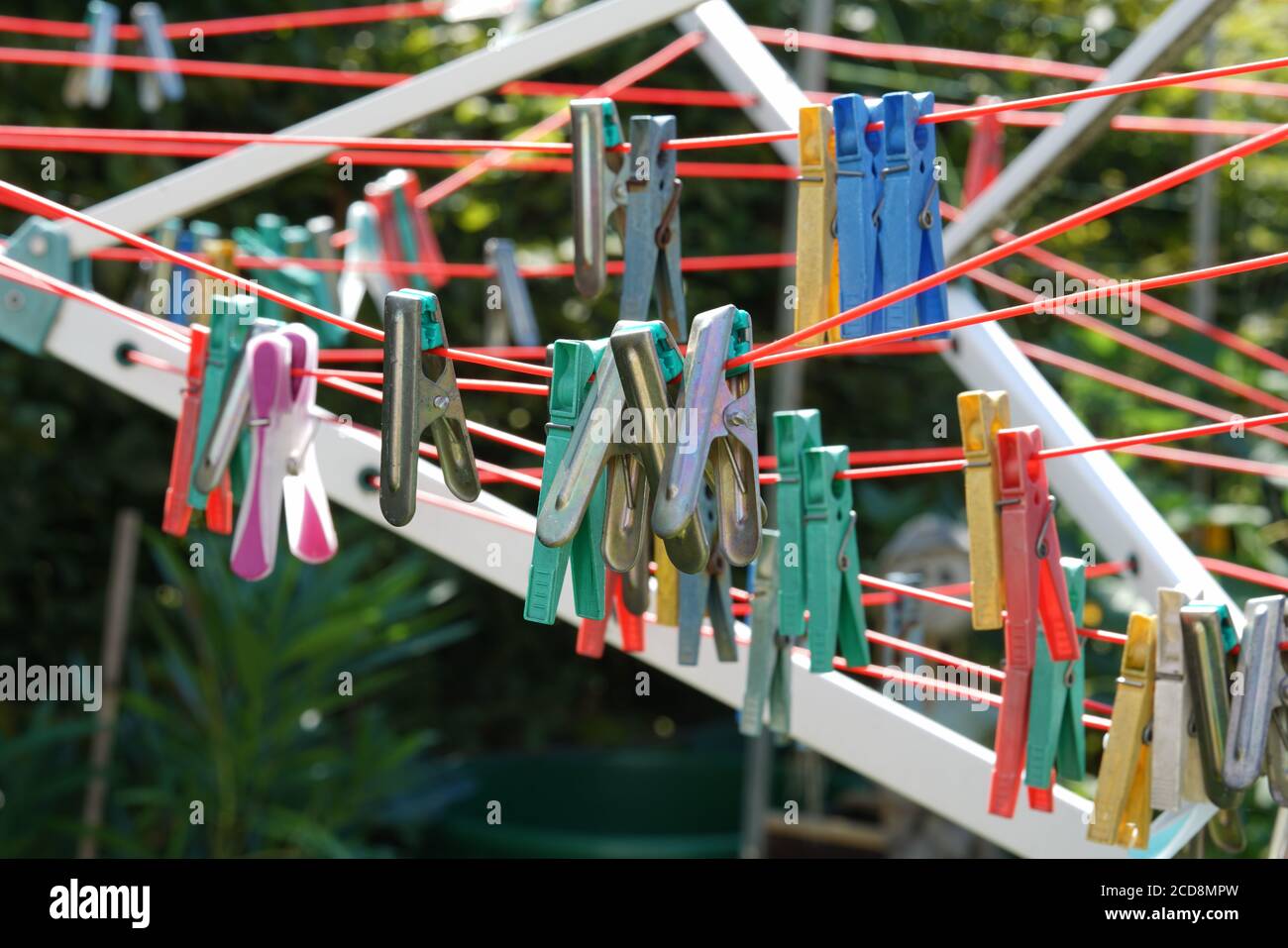 Closeup of colored clothespins on a clothesline Stock Photo