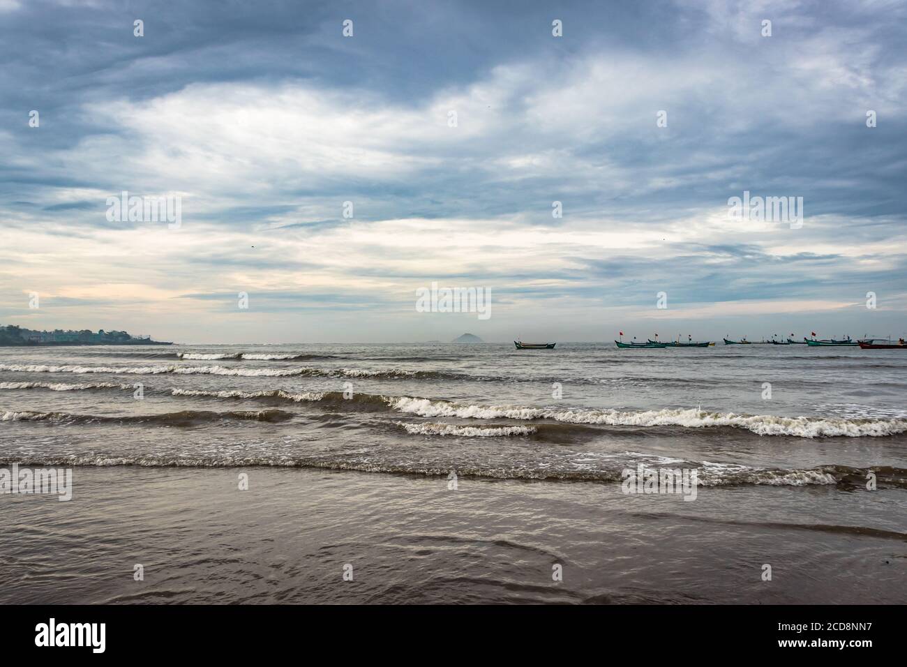 beach view with sea waves at early in the morning from low angle image is take at murdeshwar karnataka india at early morning. it is the very holy as Stock Photo