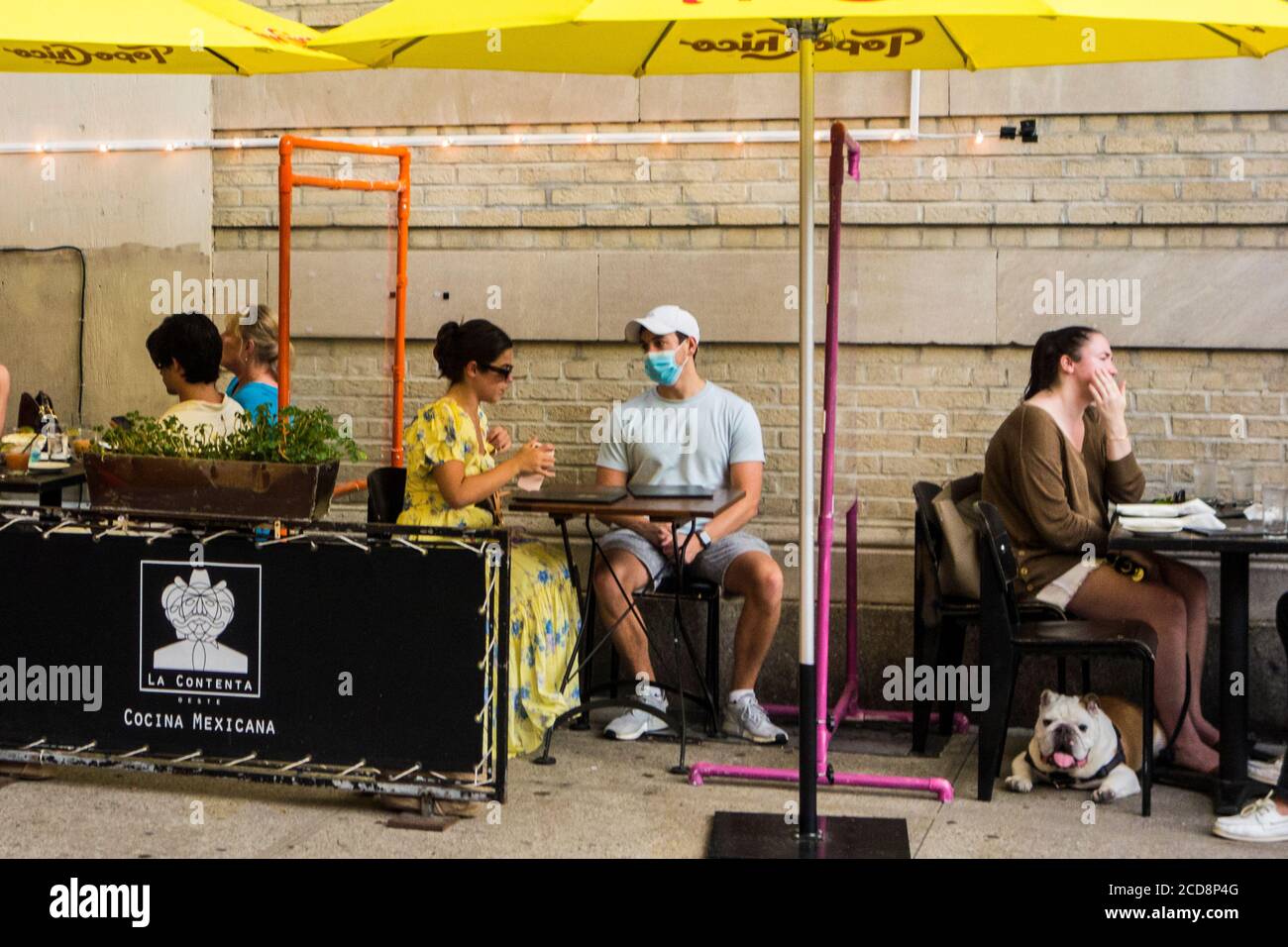 Outdoor seating with protective plexiglass screens during the Covid 19 pandemic at La Cocina Oeste Mexican Restaurant, New York City, NY, USA Stock Photo