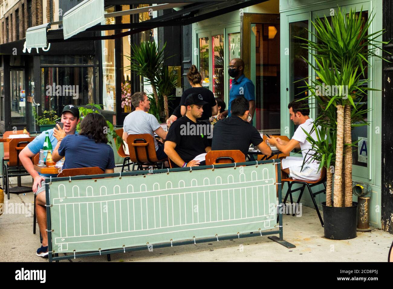 Outdoor seating during the Covid 19 pandemic at Quality Eats Restaurant on Greenwich Avenue in Greenwich Village, New York City, NY, USA Stock Photo
