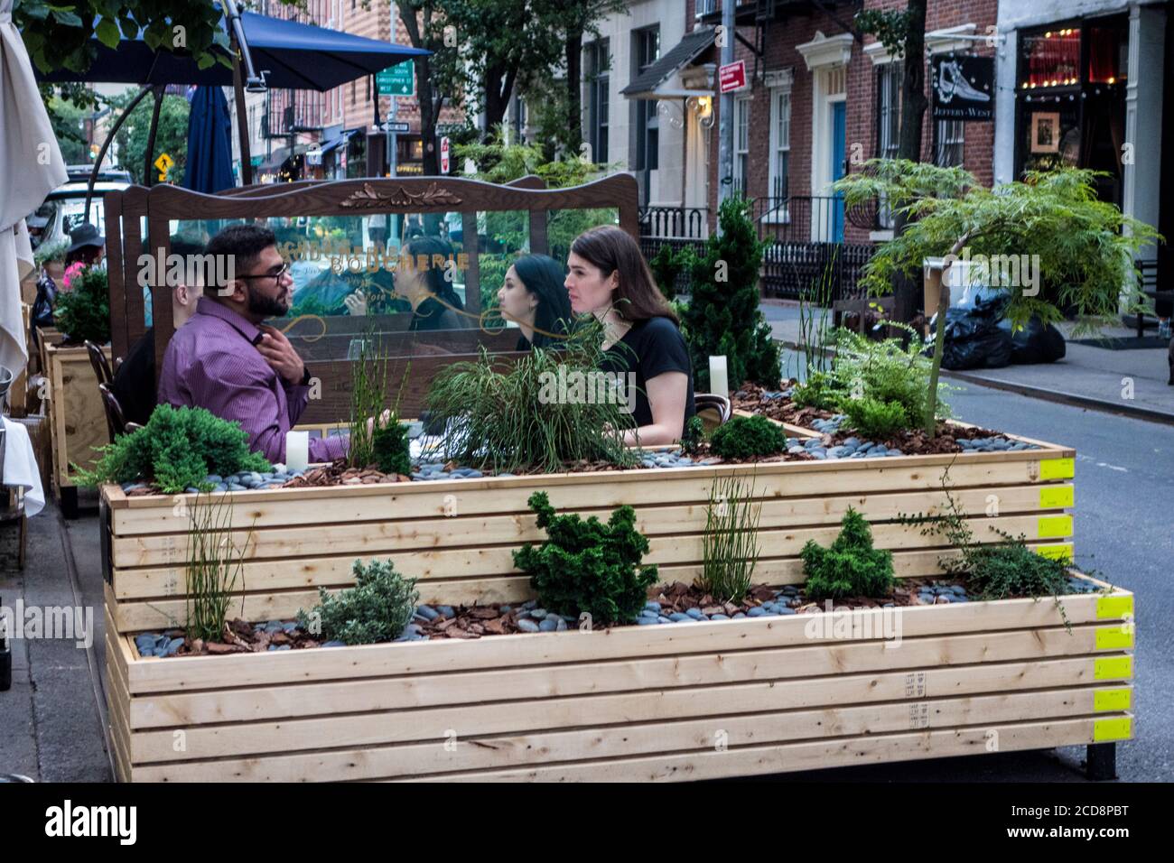 Outdoor Seating During The Covid 19 Pandemic At Petit Boucherie Bistro With Protective Plexiglass Screens In Greenwich Village New York City Ny Usa Stock Photo Alamy