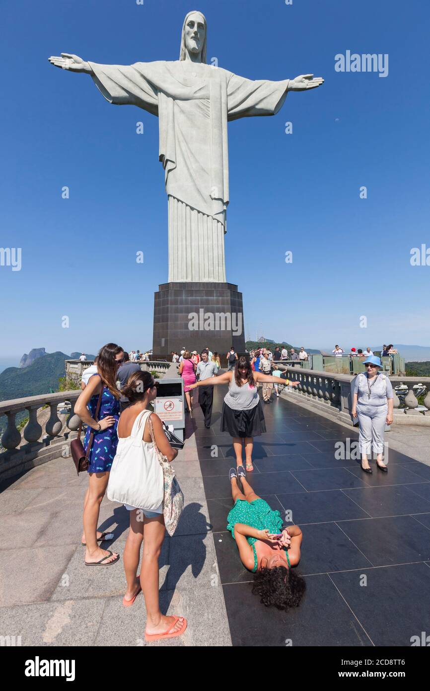 Brazil, state of Rio de Janeiro, city of Rio de Janeiro, hill of Corcovado, Carioca landscapes between the mountain and the sea classified World Heritage of UNESCO, tourists taking a picture in front of Christ the Redeemer Statue Stock Photo