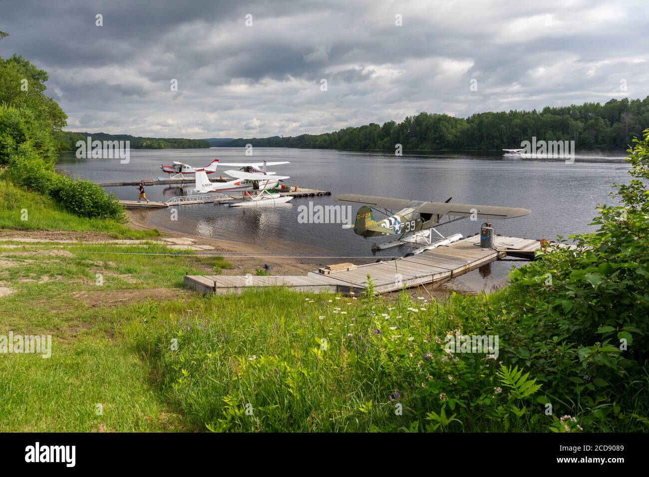 Canada, Province of Quebec, Mauricie region, Hydravion Aventure, the docks in which are seen the seaplanes on the hydrobase installed along the Saint-Maurice river under a stormy sky Stock Photo