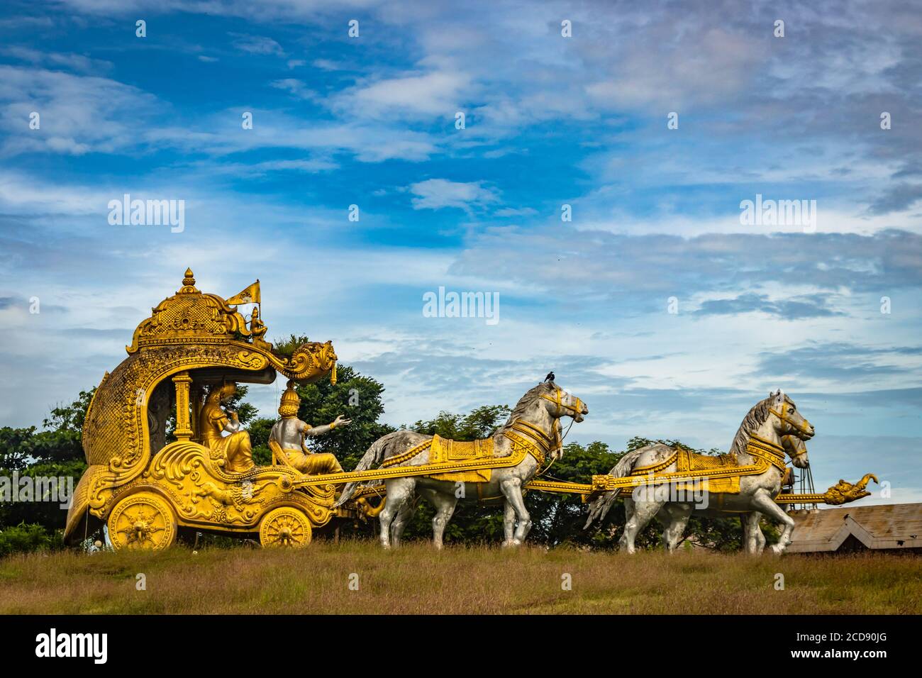 holly Arjuna chariot of Mahabharata in golden color with amazing sky background image is taken at murdeshwar karnataka india. Stock Photo