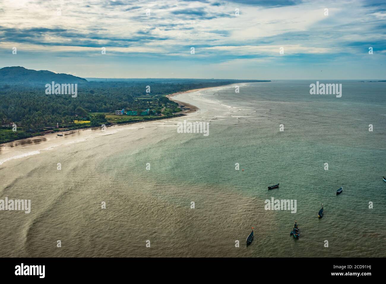 beach isolated with fishing boats aerial shots with dramatic sky image is take at murdeshwar karnataka india at early morning. it is the very holy as Stock Photo
