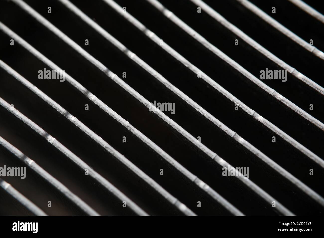 Dark gray metal grating in low light technique Stock Photo