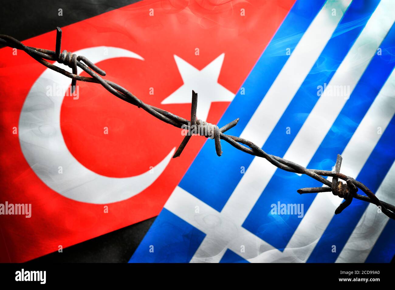 The flags of Turkey and Greece behind barbwire, Aegean dispute Stock Photo