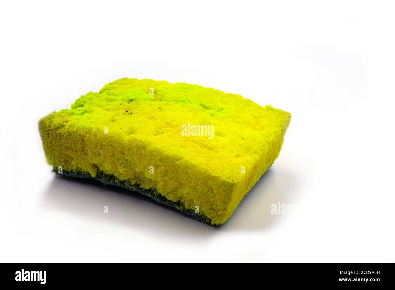 Used yellow sponge for dishwashing photo on white background. Foam rubber sponge with microbe and bacteria. House cleaning tools. Used household item. Stock Photo