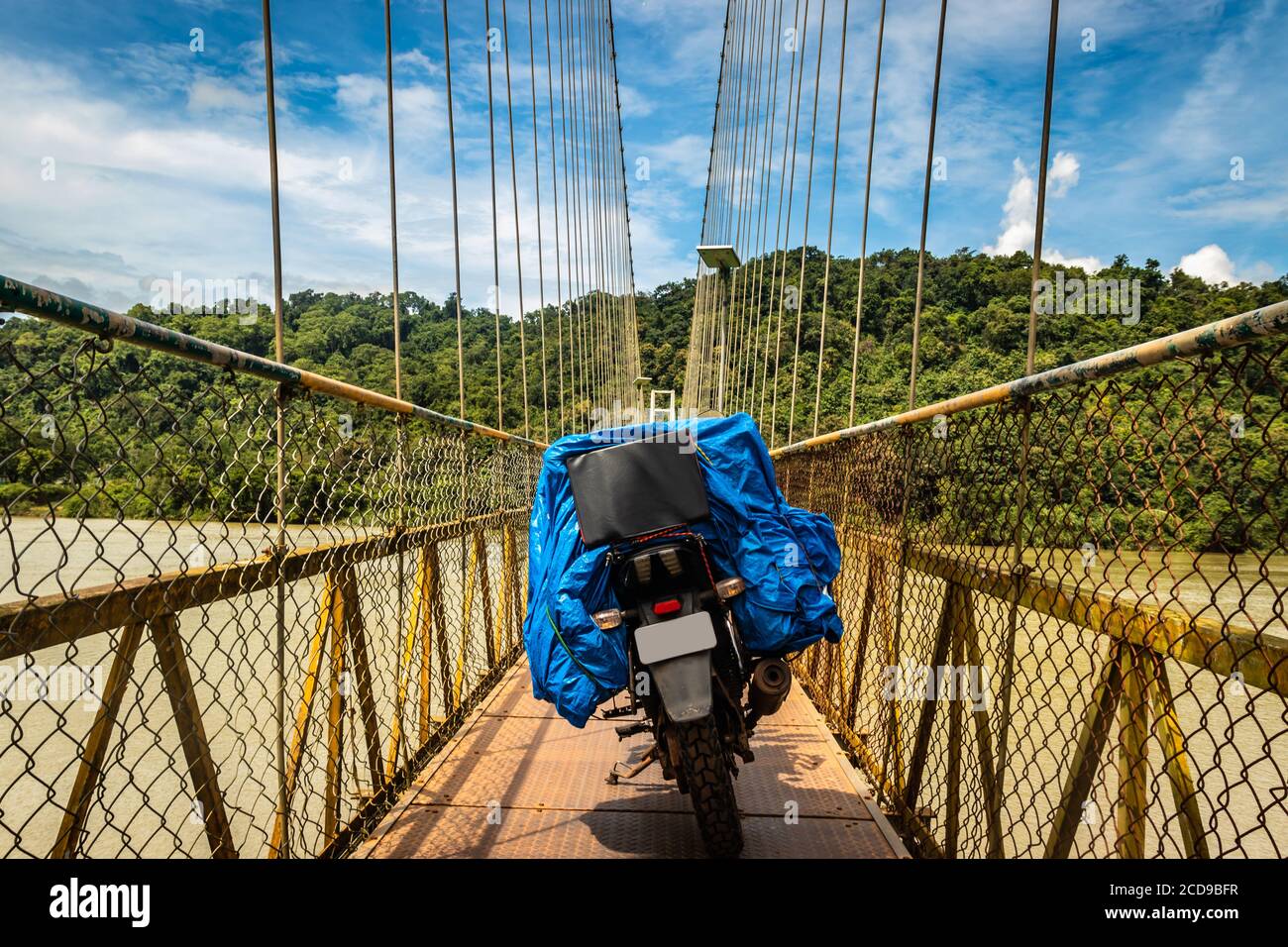 solo rider loaded motorcycle parked isolated on suspension bridge image is taken at honnavar karnataka india. it is an amazing experience to ride moto Stock Photo