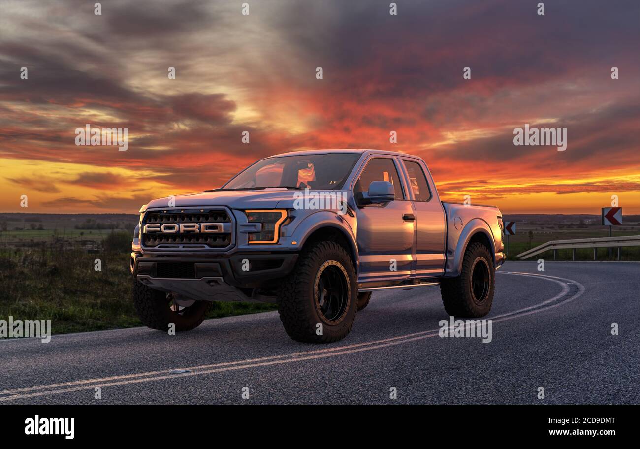 Ford F-150 Raptor - Most Extreme Production Truck On The Planet standing on the road at sunset Stock Photo