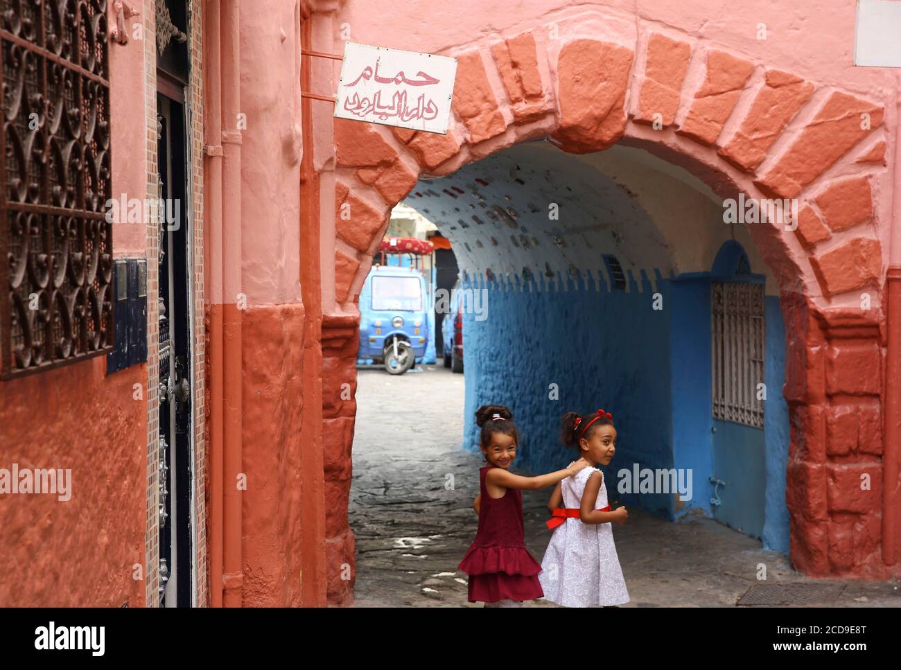 Morocco, Tangier Tetouan region, Tangier, Moroccan girls in dress in a colorful alley of the medina Stock Photo