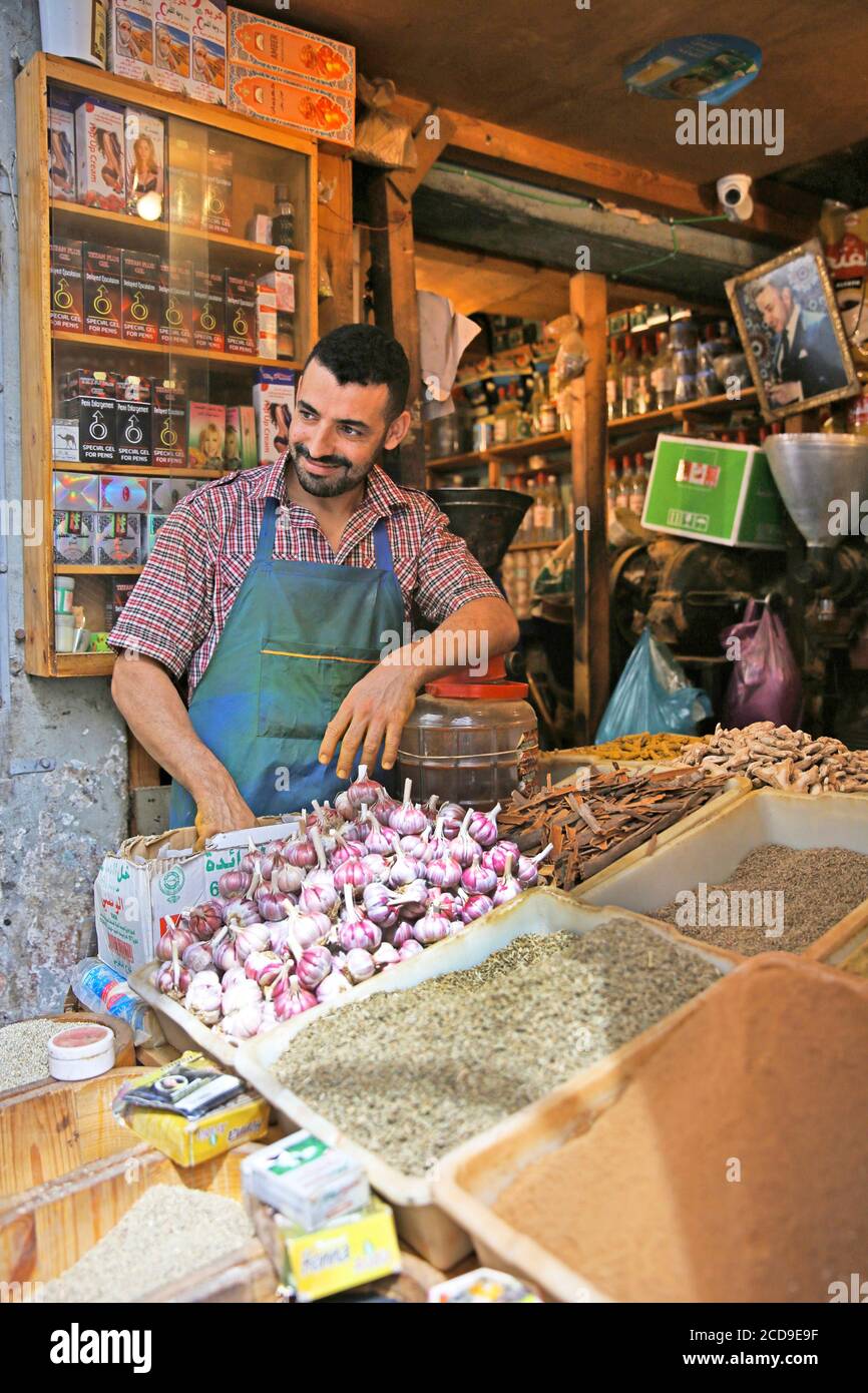 Morocco, Tangier Tetouan region, Tangier, Moroccan merchant in front of the stalls of spices Stock Photo