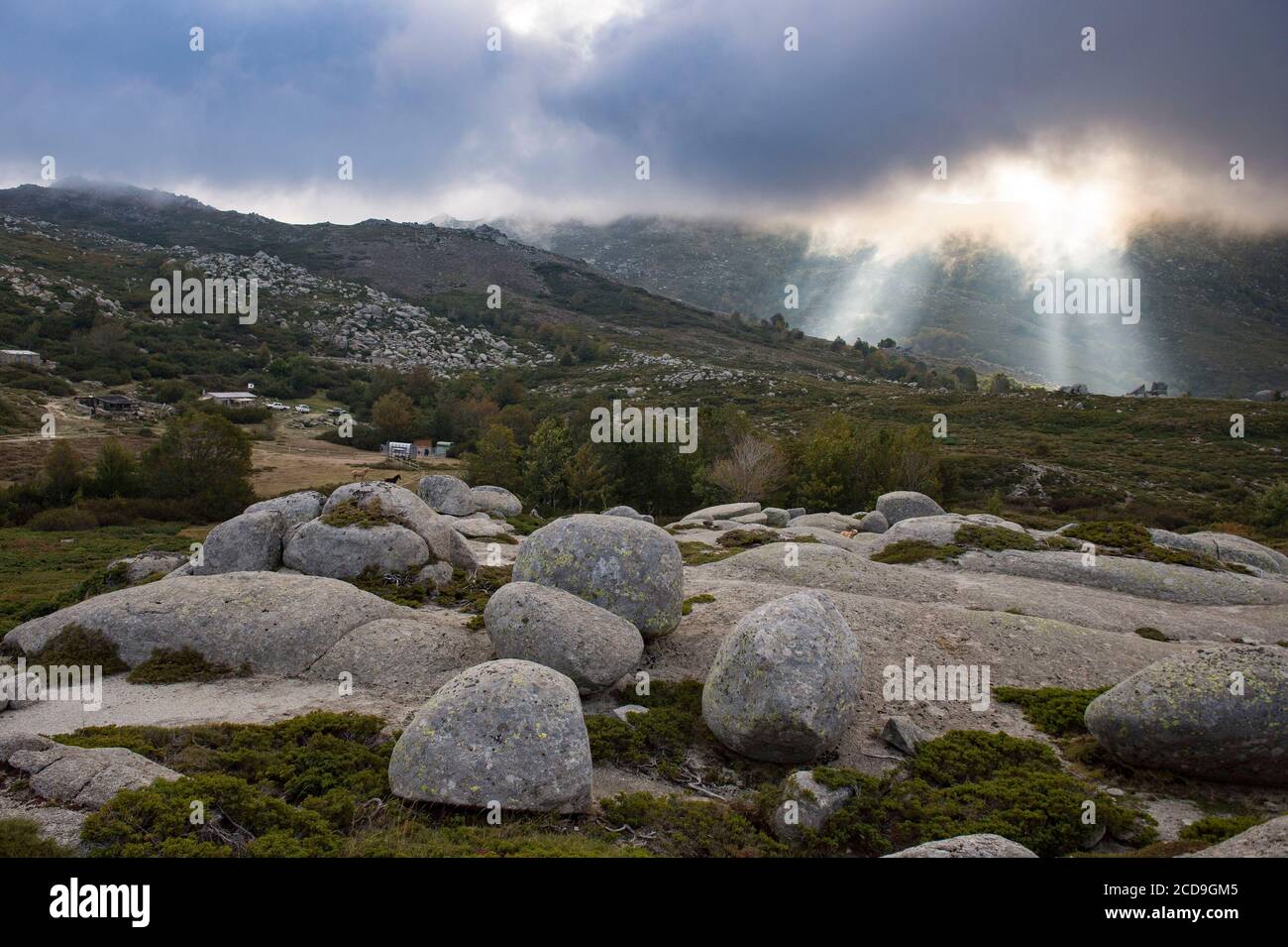 France, Corse du Sud, Alta Rocca, plateau of Coscione, light effect and sunbeam through clouds towards the sheepfolds of Chiralbella Stock Photo