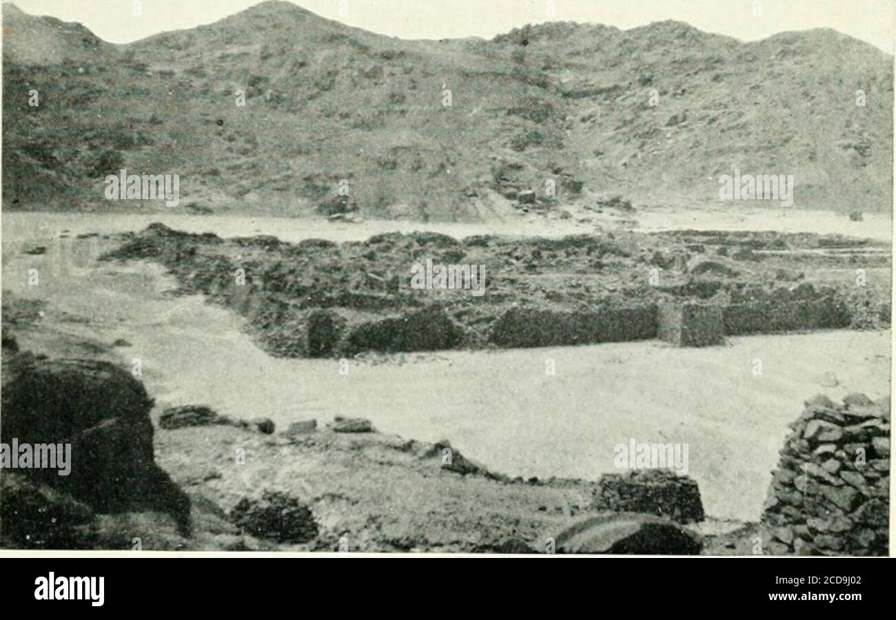 . Travels in the Upper Egyptian deserts . The ruins of the town of Gebel Dukhan. The upright pillarsof granite supported a roof.—Page 106.. The Roman town of Mons Claudianus, looking south from the cause-way leading to the main quarry. The round piles of stone in theforeground are built at intervals along the causeway. — Page 124. Pl. xix. V. THE QUAREIES OF MONS CLAUDIANUS. In the previous chapter an account was given ofa journey made to the Imperial porphyry quarriesof Gebel Dukhan in the month of March 1907.These quarries are to be found about a score orso of miles from the Red Sea at a poi Stock Photo