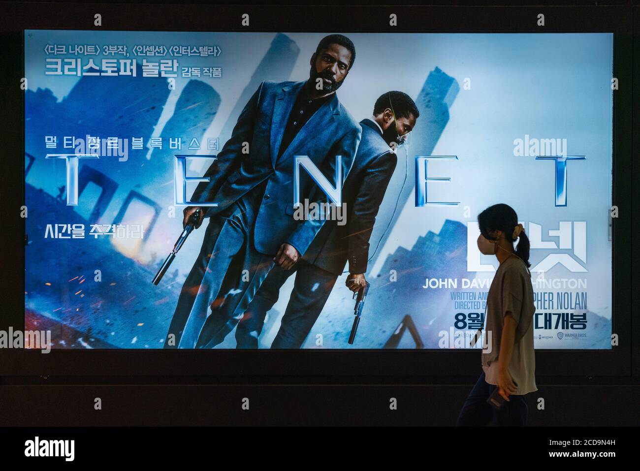 Seoul, South Korea. 26th Aug, 2020. A woman wearing protective mask walks by a billboard of the movie 'TENET'.Movie 'TENET' directed by Christopher Nolan is released on 26 August in South Korea for the first time in the world. Credit: SOPA Images Limited/Alamy Live News Stock Photo