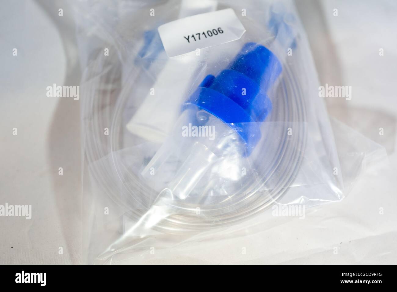 Closeup of nebulizer respiratory therapy supplies including nebulizer mask in plastic bag on