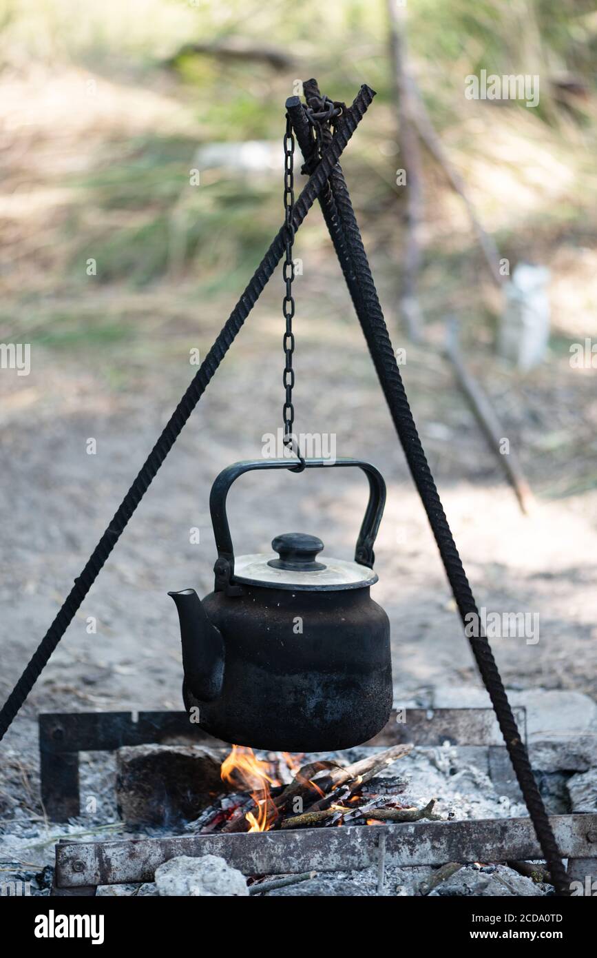 An Old Kettle Over The Camp Fire. The Kettle Boils Water For Tea Stock  Photo, Picture and Royalty Free Image. Image 84570904.