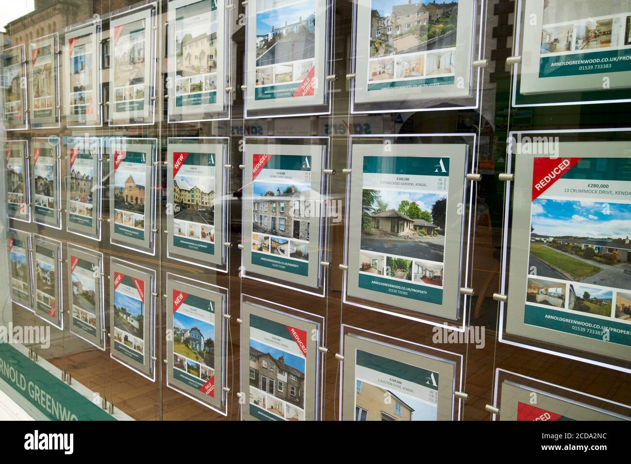 properties for sale in the window of an estate agency in Kendal cumbria england uk Stock Photo