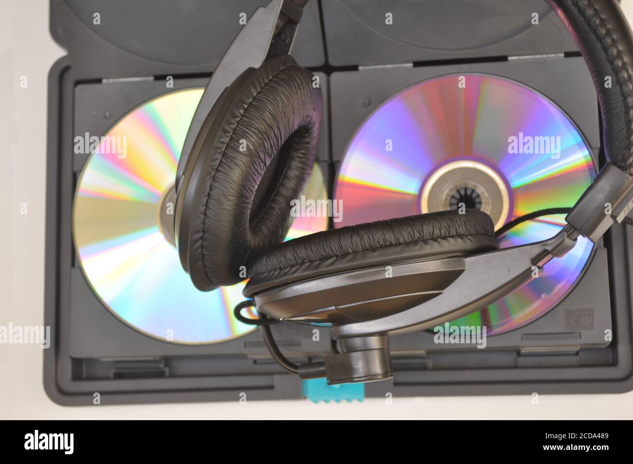 Headphone and compact disc cd in thermal case on white background top view and acrylic cover Stock Photo