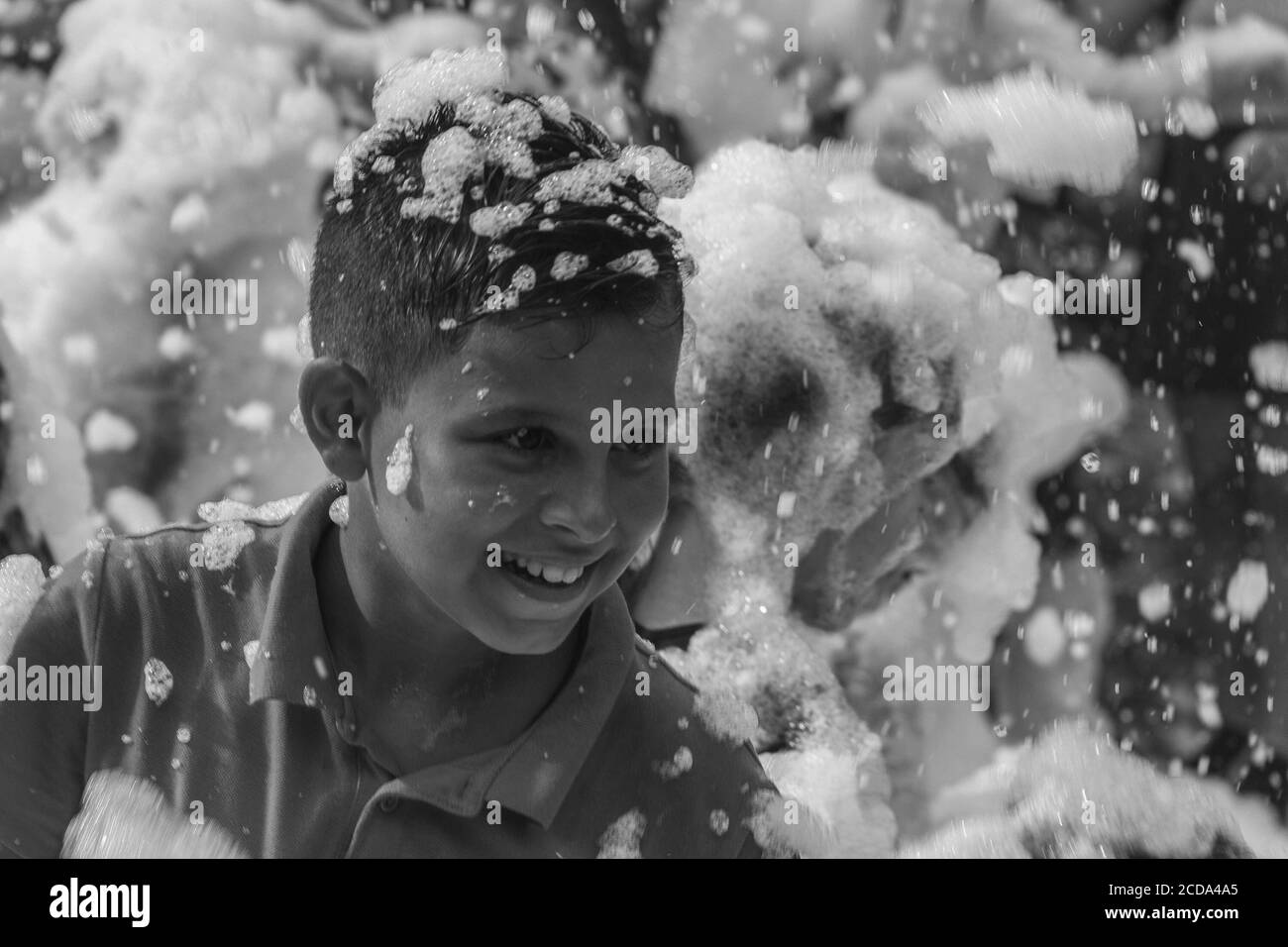 Kamennomostsky, Russia - September 1, 2018: Happy children having fun at a foam party at a holiday town day Kamennomostsky in an autumn park black and Stock Photo