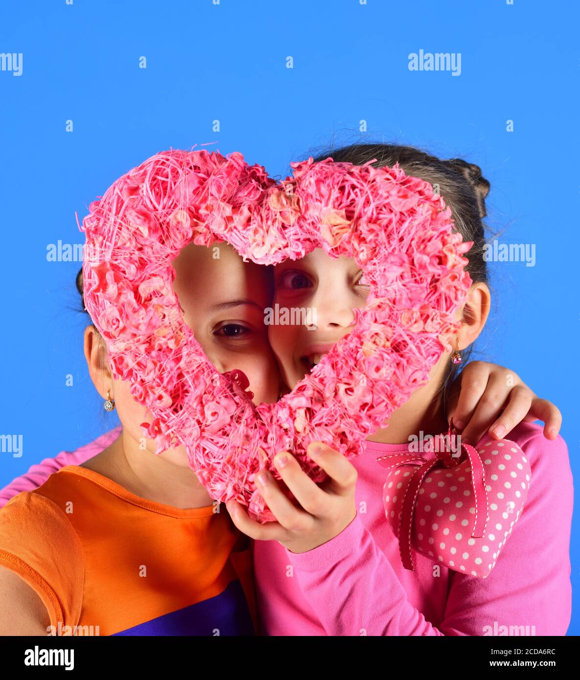 Sisters With Paper Furry Heart Girls With Hidden Smiling Faces Look Through Decorative Heart On Blue Background Children Celebrate Valentines Day Love And Valentines Party Concept Stock Photo Alamy
