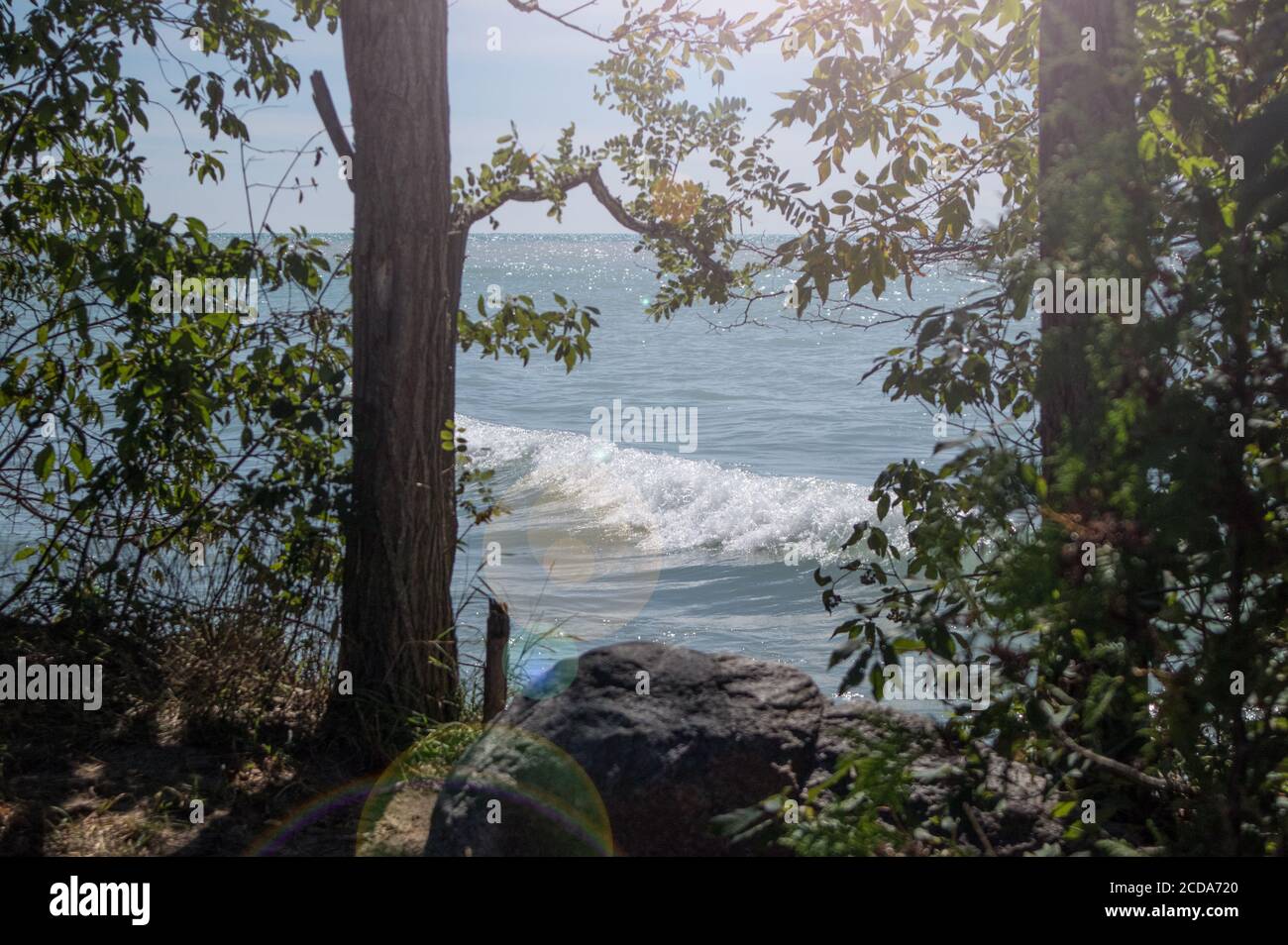 Lake Huron is seen through trees in Bayfield Stock Photo Alamy