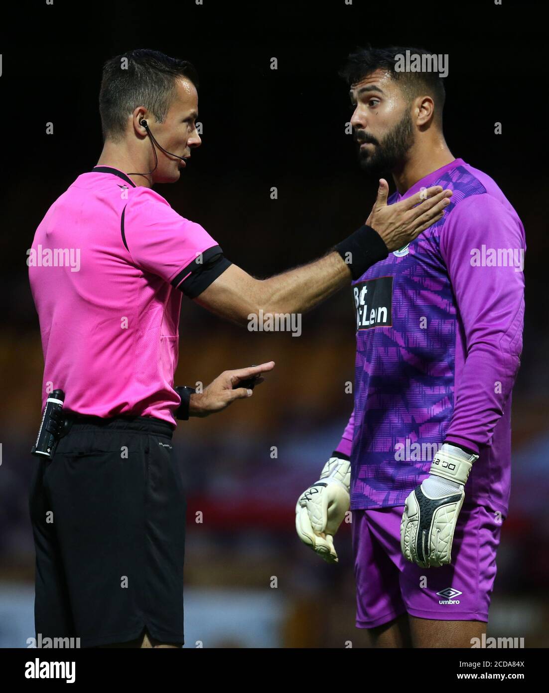 Glentoran's Dayle Coleing (right) and referee Bram Van Driessche during the UEFA Europa League qualifying first round match at Fir Park, Motherwell. Stock Photo