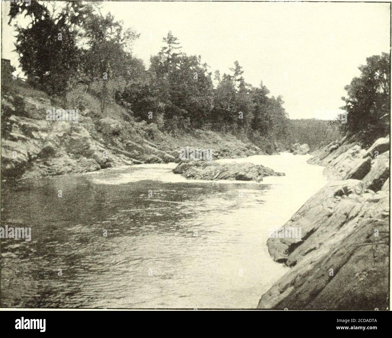 . Water Supply and Irrigation Papers of the United States Geological Survey . A. RUMFORD FALLS, LOOKING DOWNSTREAM TOWARD MIDDLE-LEVEL CANAL.. li. SACO RIVER BELOW SALMON FALLS DAM. PRESSEY.] ANDROSCOGGIN RIVER. 77 Gage ratings are taken at the lower dam. At first they were madeonce a day, later four times a day, and now every two hours. Flash-boards are not used on the dam. There is but little fluctuationduring the twenty-four hours in the quantity passing the weirs; infact, there is not much fluctuation anywhere upon the river except atand below Lewiston, where a large proportion of the mill Stock Photo