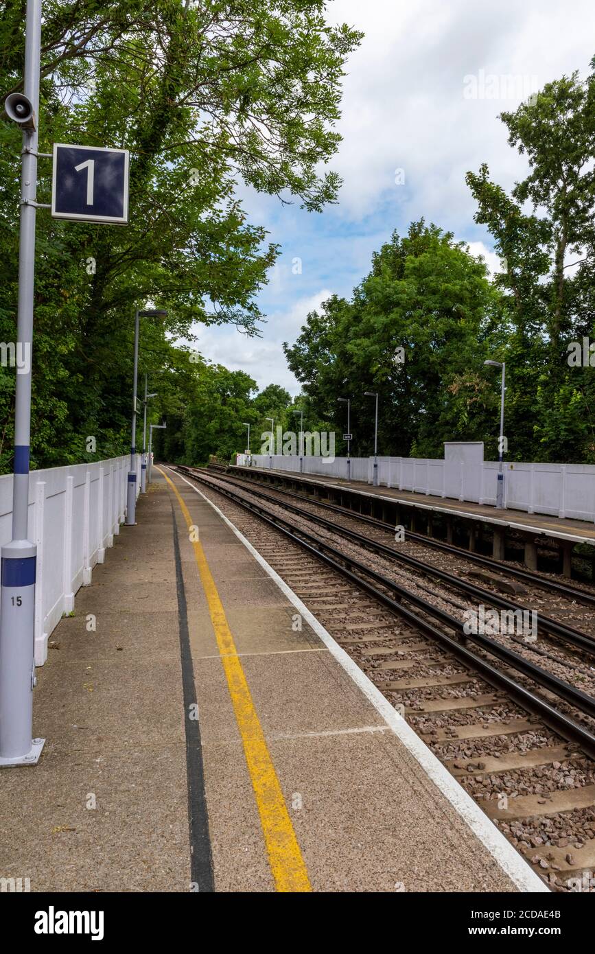 an empty suburban railway station platform during the coronavirus covid 19 outbreak with commuters not travelling into the city of london to work. Stock Photo