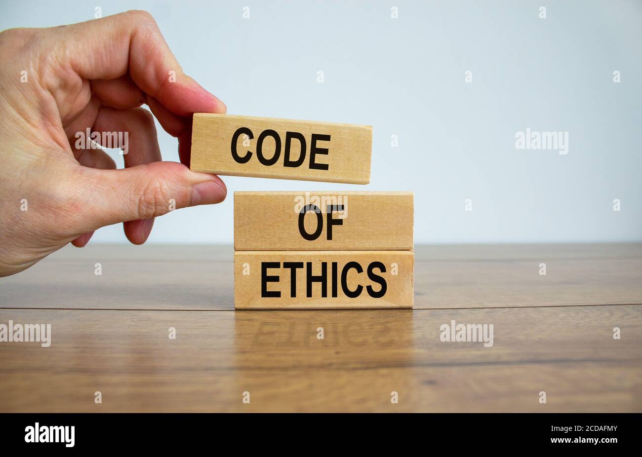 Morals Code Tapping Male hand placing a blocks with word 'code' on top of a blocks tower ...