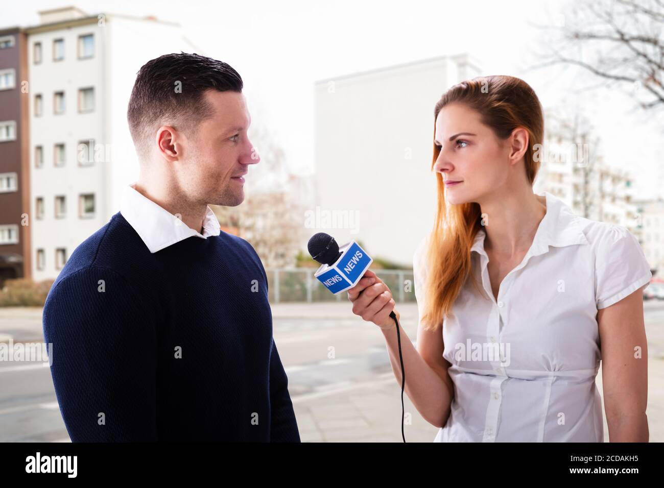 News Press Journalist Interview Using Microphone. Two Persons Stock Photo