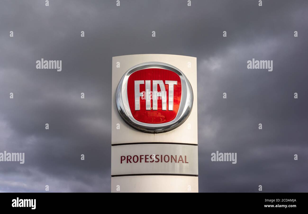 FIAT Professional sign outside a Fiat car dealer showroom surrounded by dark grey clouds in Southampton, England, UK Stock Photo