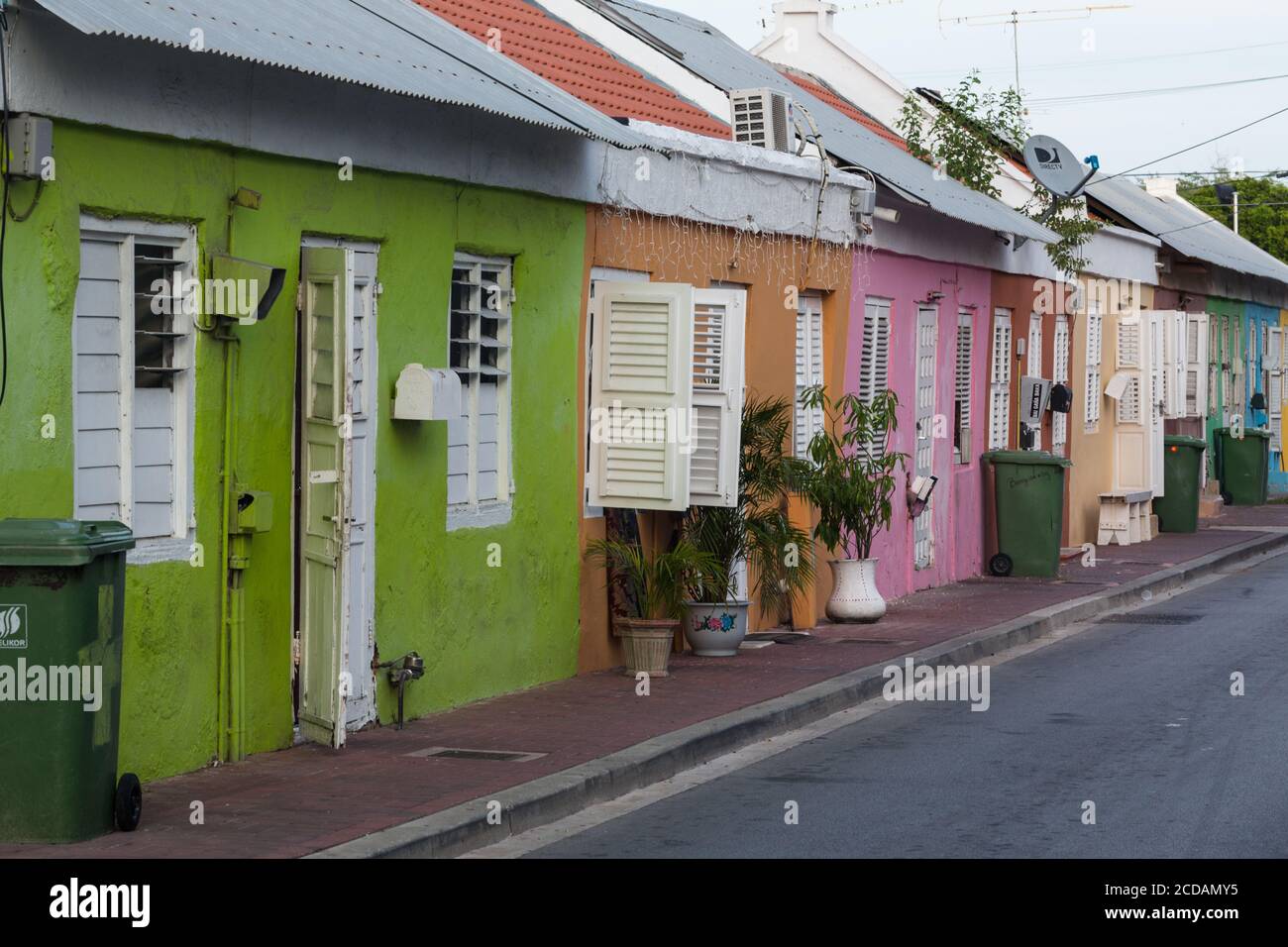 Colorful late 19th century row houses in a poorer neighborhood in Willemstad, the capital of the Caribbean island of Curacao in the Netherlands Antill Stock Photo