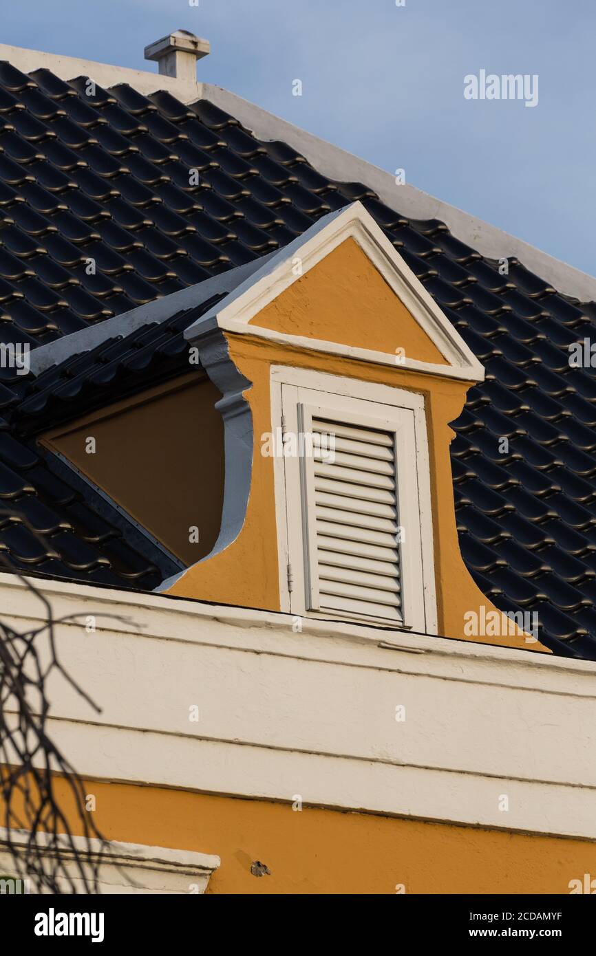 Architectural detail of a dormer window in an historic house in the Scharloo neighborhood of the Punda district of Willemstad.  The Historic Area of W Stock Photo