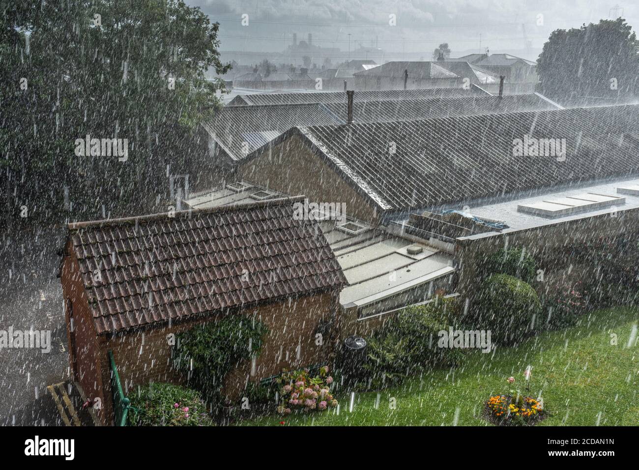 Torrential rainfall / heavy rain during summer over urban buildings in Southern England, bad weather in the UK Stock Photo