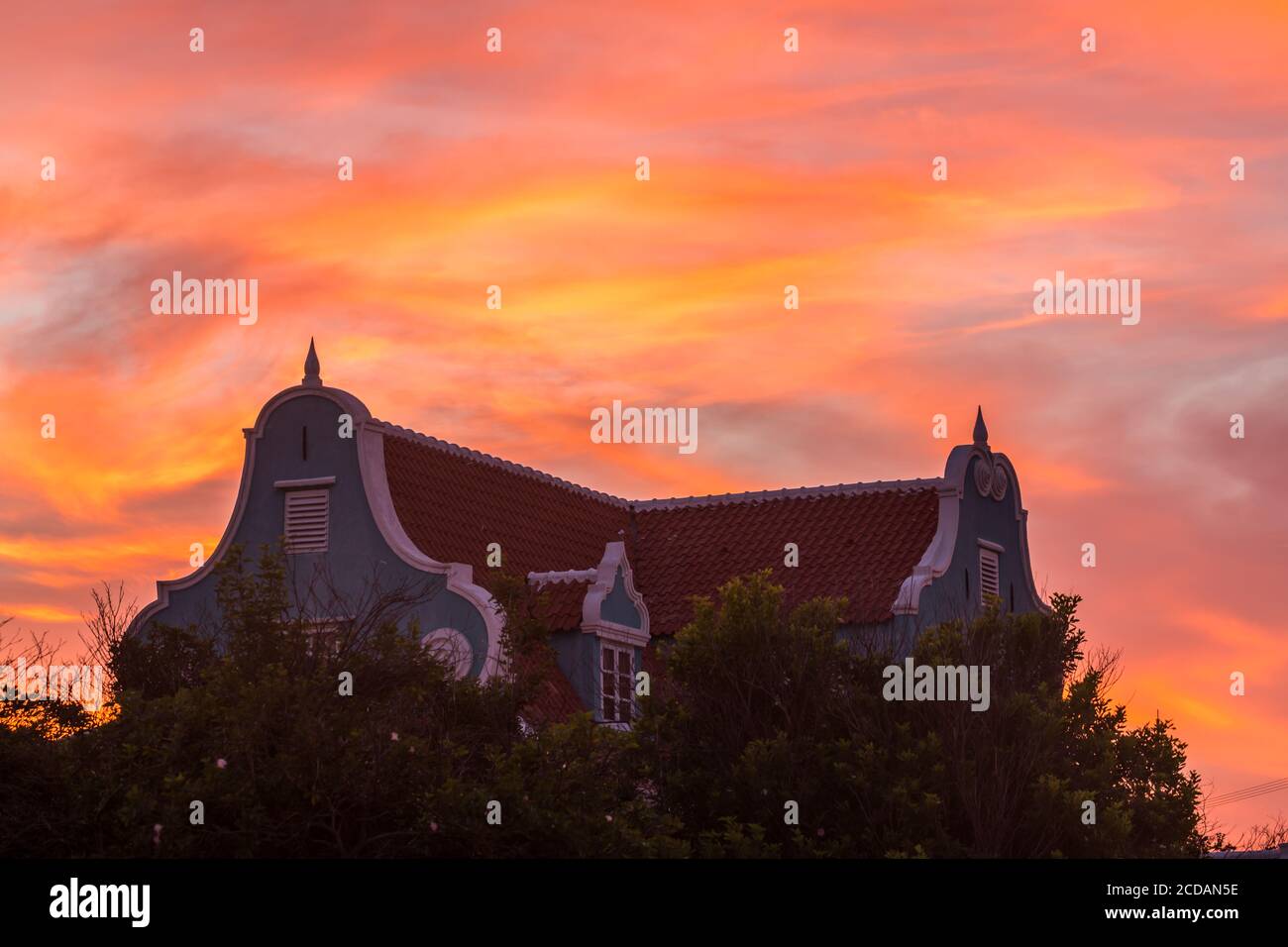 Sunset clouds behind an historic building with Dutch colonial architecture in the Otrobanda district of Willemstad, the capital of the Caribbean islan Stock Photo