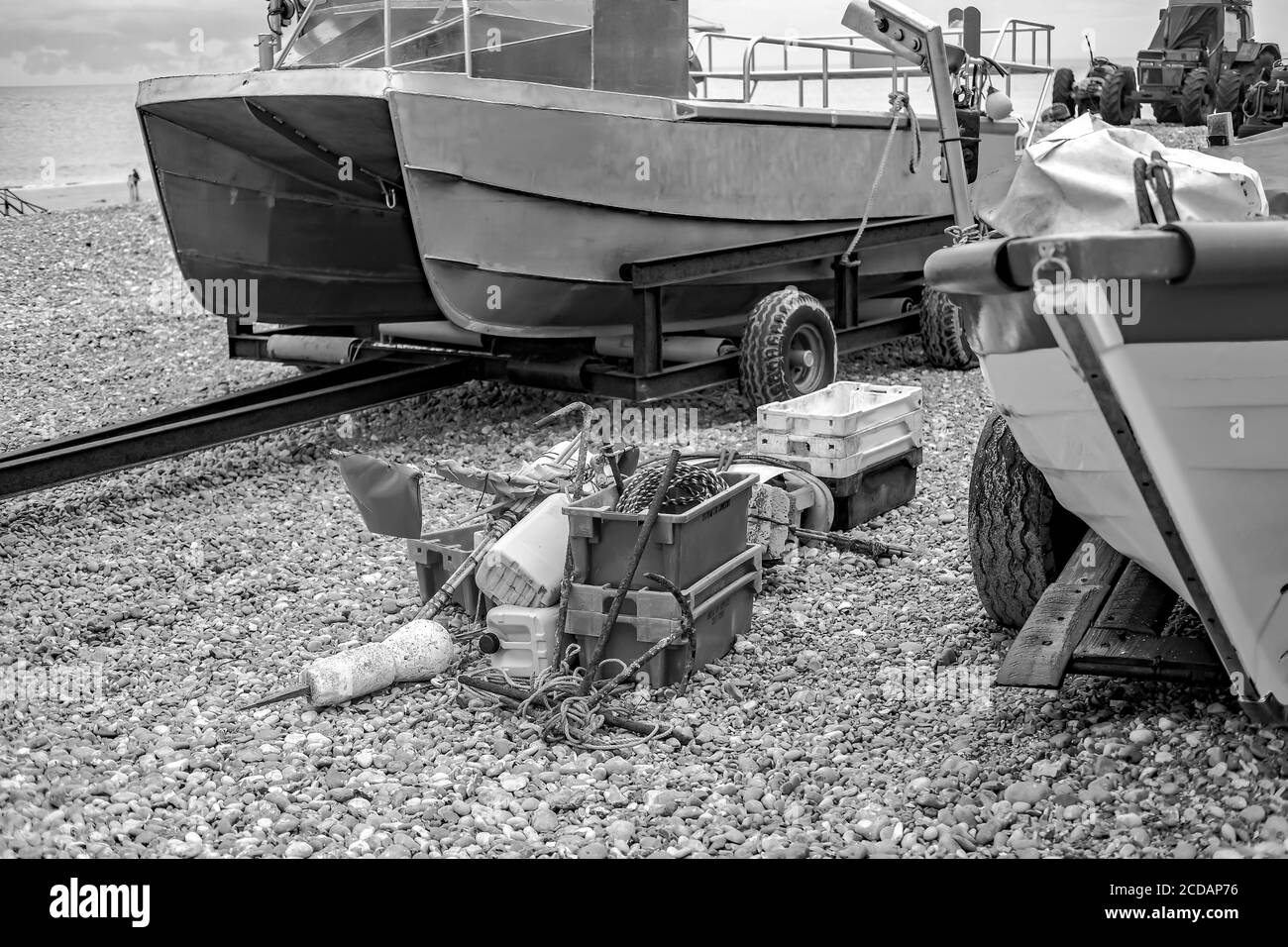 https://c8.alamy.com/comp/2CDAP76/a-black-and-white-photo-of-a-selective-focus-on-fishing-gear-on-a-shingle-beach-surrounded-by-fishing-boats-this-is-a-scene-on-cromer-beach-a-famous-crab-fishing-beach-on-the-north-norfolk-coast-2CDAP76.jpg