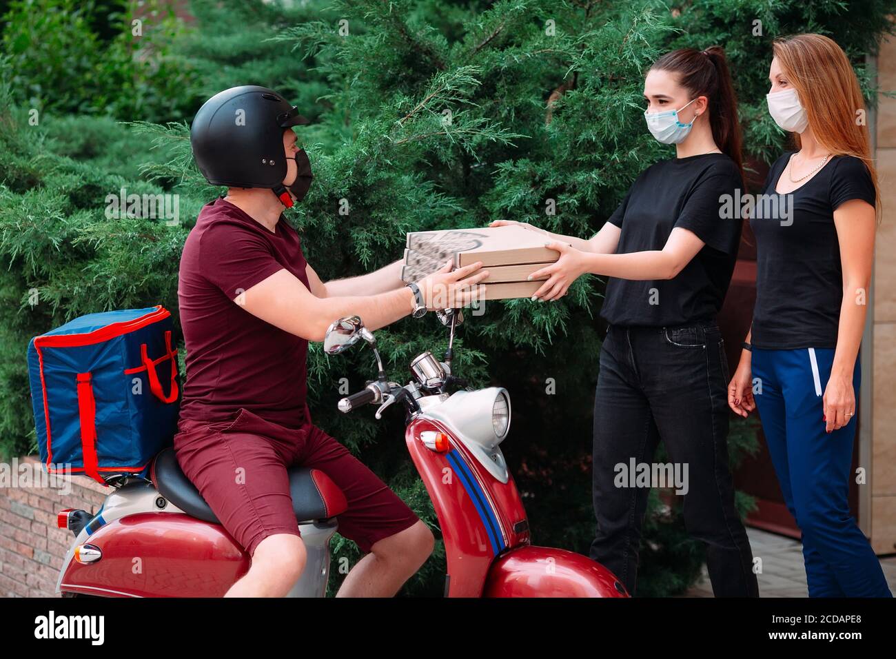 Delivery Rider Box Two womans pick up delivery food box from delivery rider with scooter ...