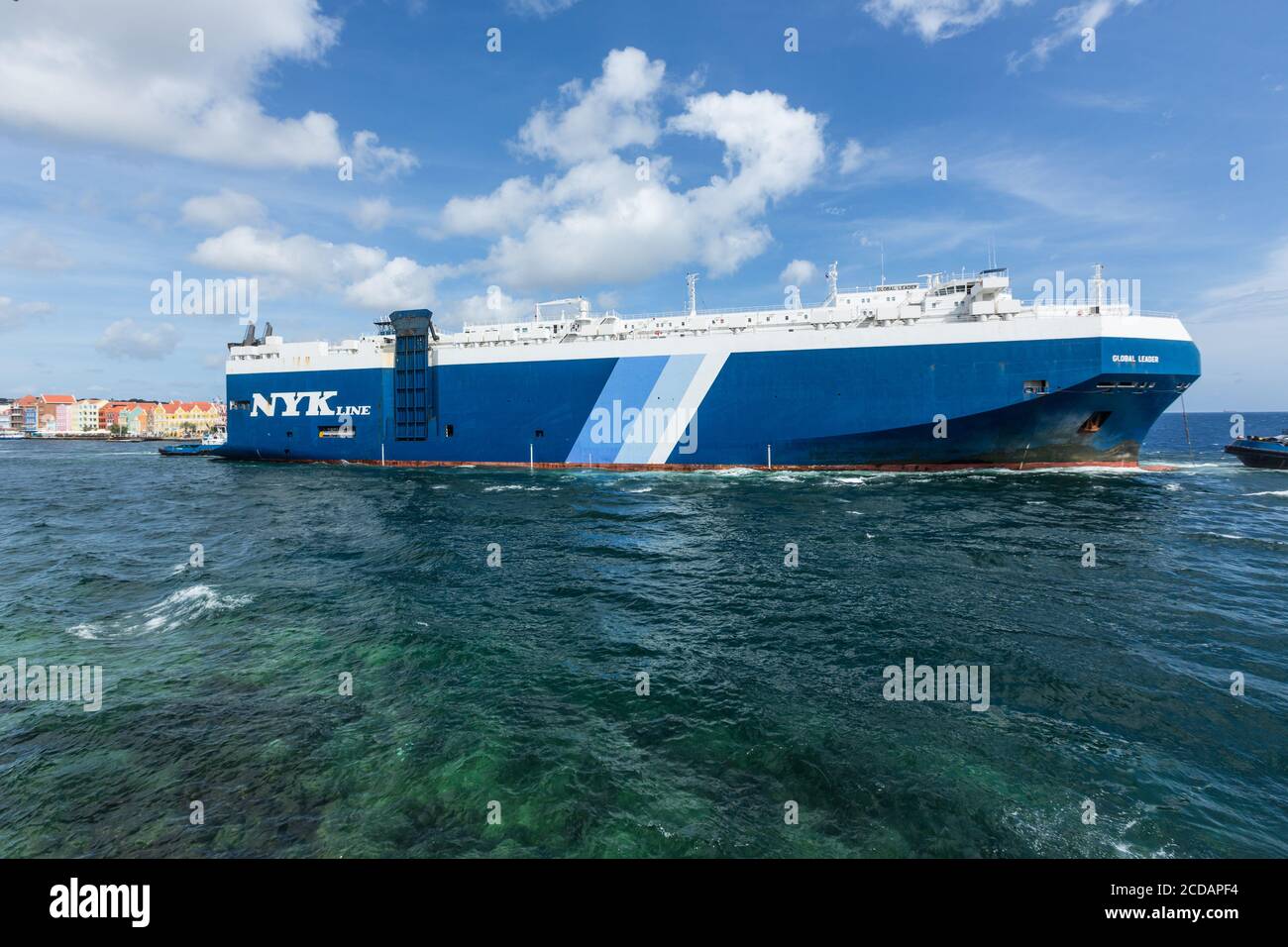 The Global Leader, a roll-on/roll-off vehicle carrier of the NYK Line, at the mouth of the harbor at Willemstad, Curacao. Stock Photo