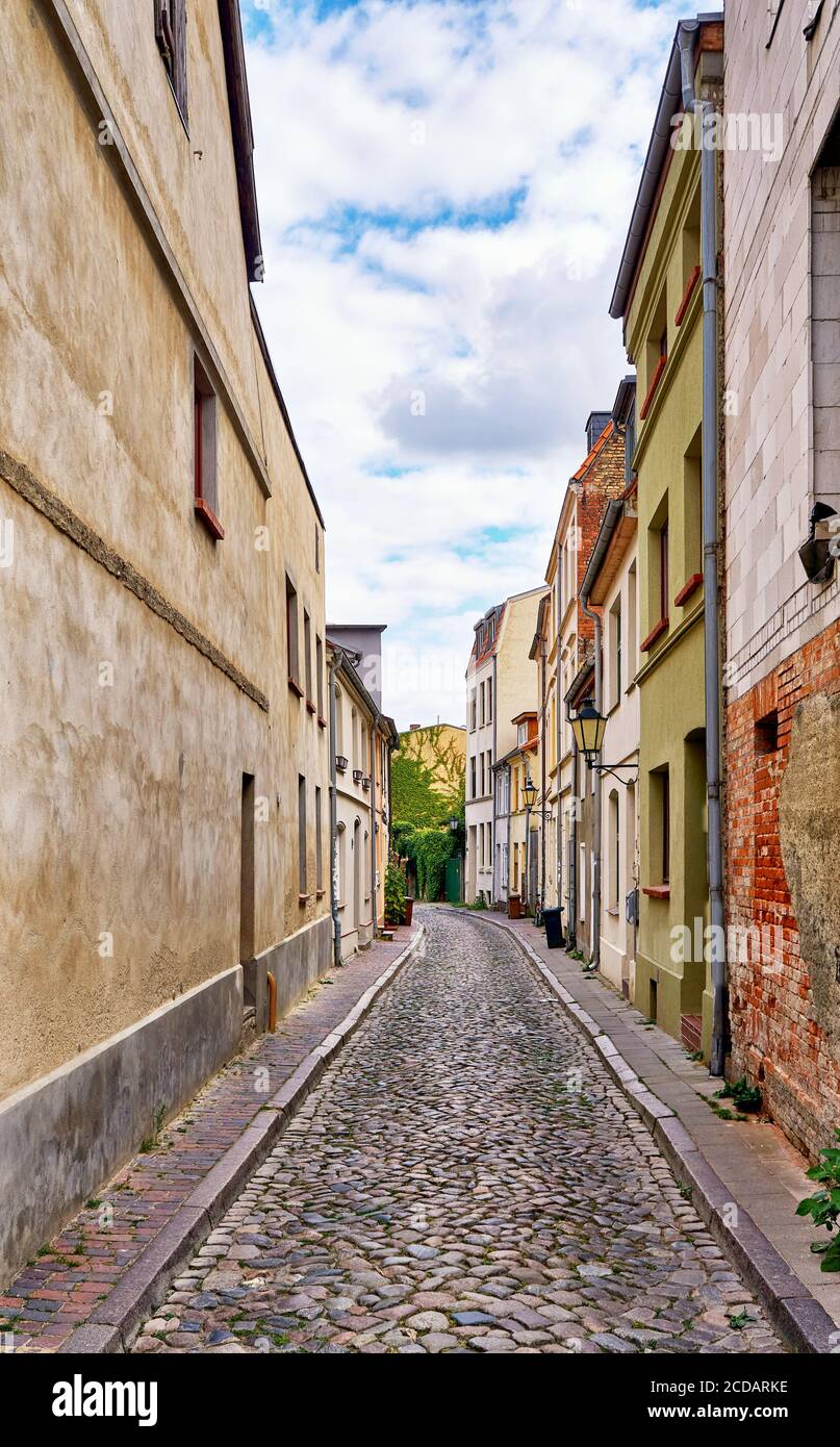 Narrow alley in the old town of Wismar. Old houses on a narrow street. Stock Photo