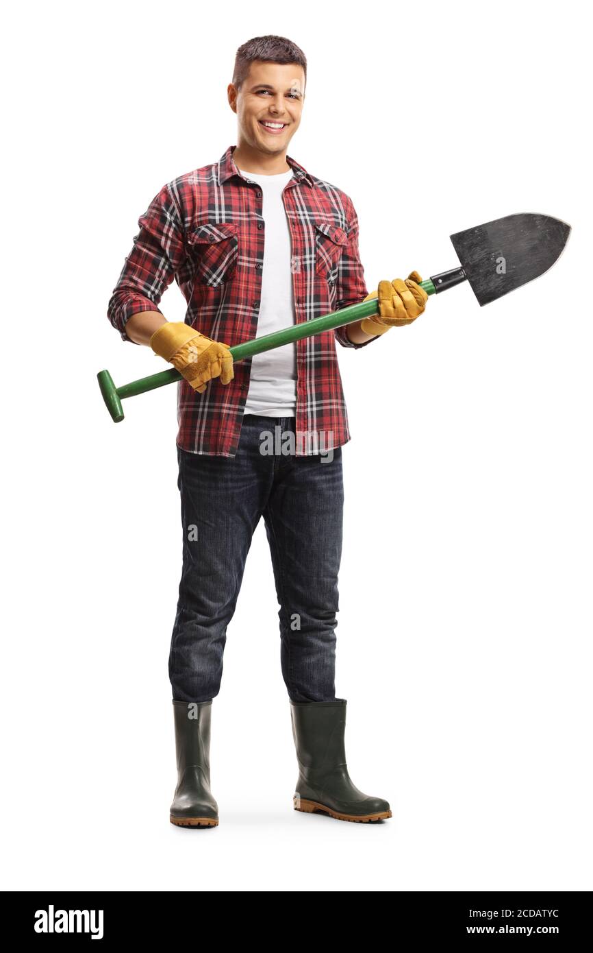 Full length portrait of a male gardener with rubber boots standing with ...