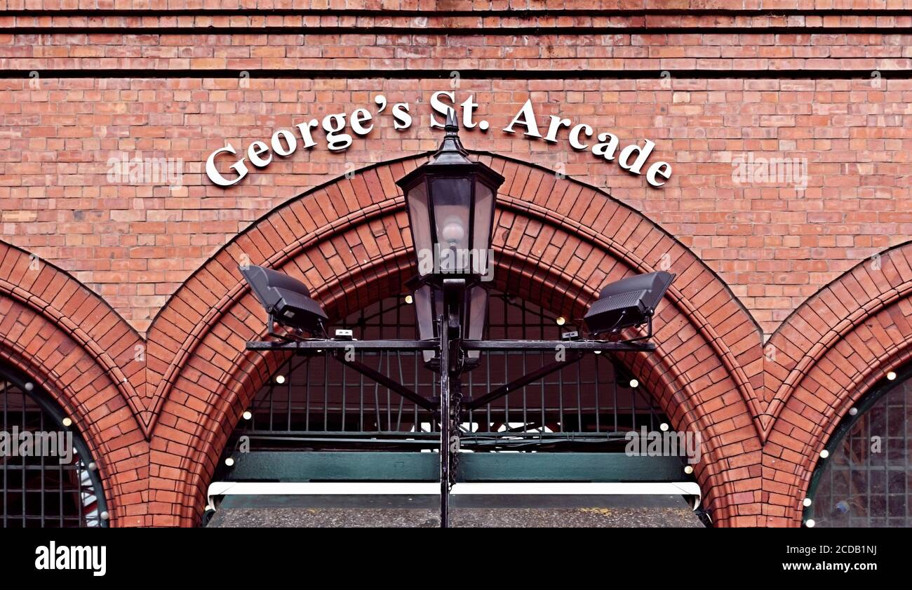 George’s Street Arcade market, exterior sign. Shopping Mall, red brick building facade, lamp post. Downtown Dublin, Ireland, Europe. Stock Photo