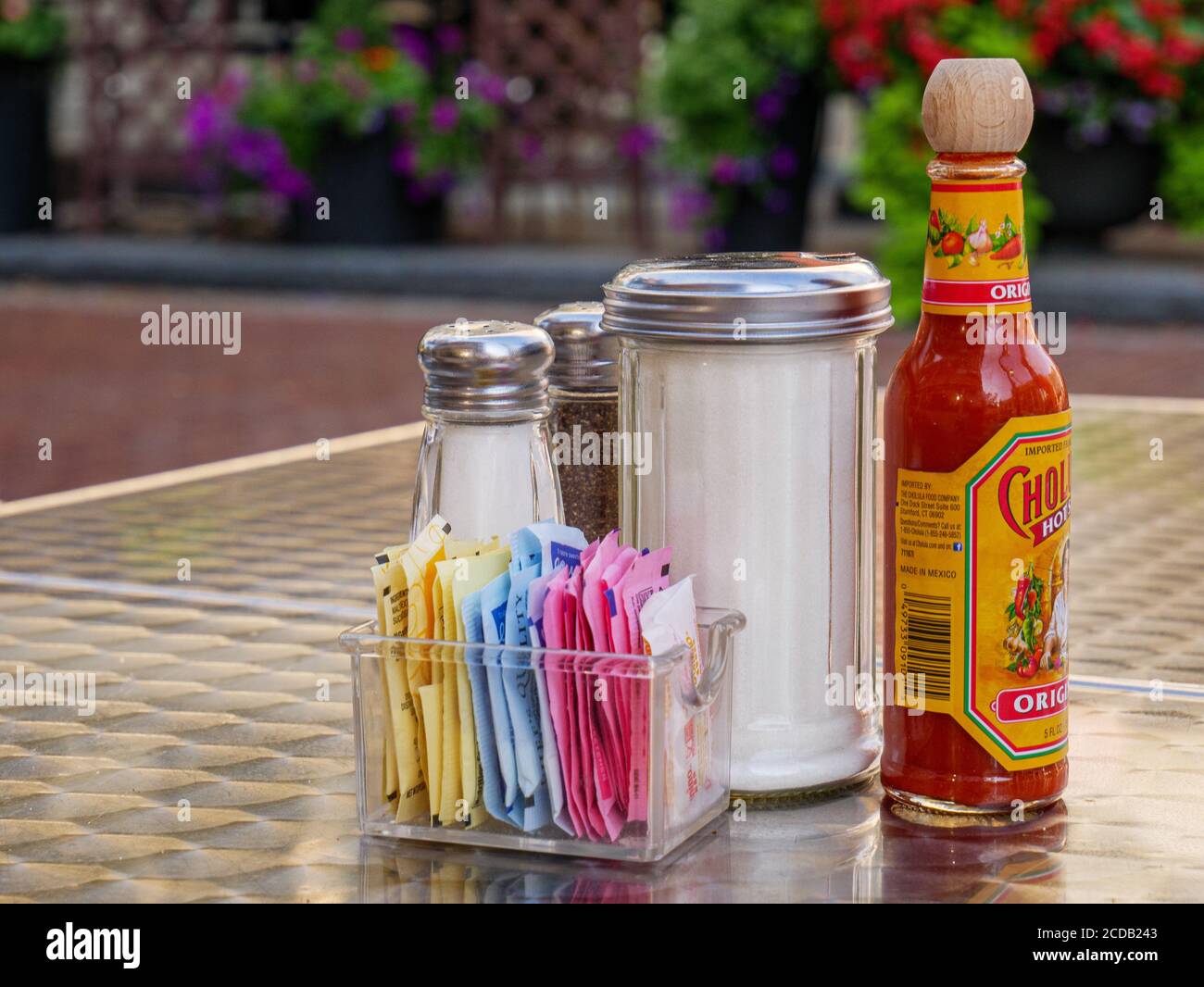 Condiments on table, restaurant outdoor eating area. Oak Park, Illinois. Stock Photo