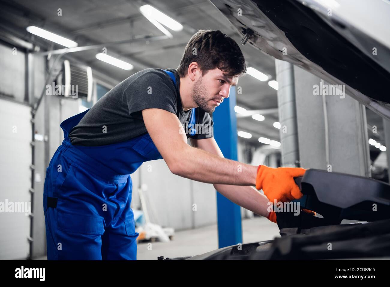 Male working car engine transportation automotive repairs hi-res stock ...